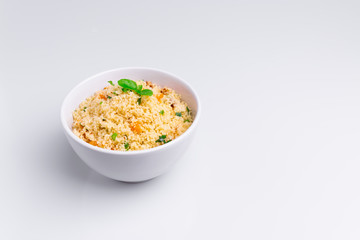 Delicious homemade vegetarian couscous with dates, raisins, parsley, tomato, lemon and olive oil in...