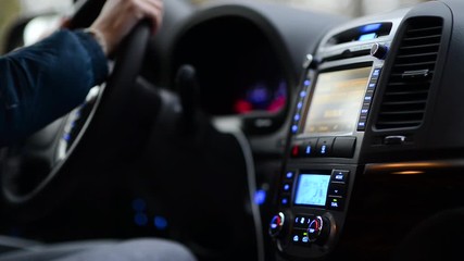 woman distracted from driving in order to adjust the air conditioning system