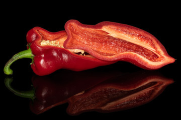 Group of two halves of sweet red bell pepper isolated on black glass