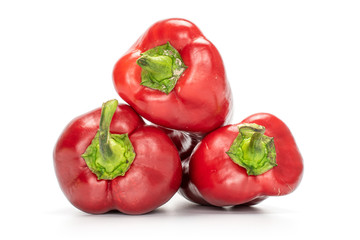 Group of three whole sweet red bell pepper isolated on white background
