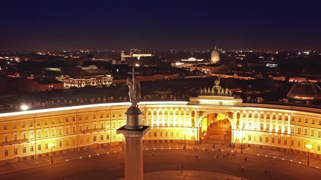 Aerial around view of the Alexander Column on Palace Square, the Winter Palace and the General Staff Building in St. Petersburg at night, Russia, 4k