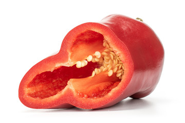 One half of sweet red bell pepper with seeds isolated on white background