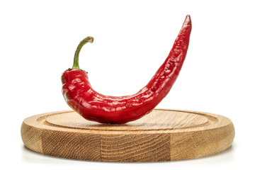 One whole fresh hot pepper on bamboo plate isolated on white background