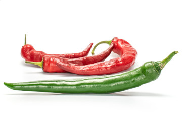Group of four whole fresh hot pepper green in focus isolated on white background