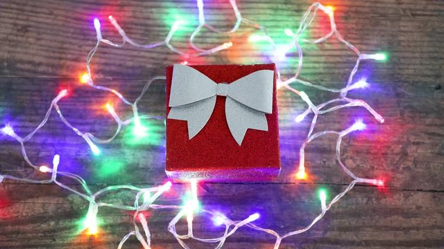 festive season timelapse with colorful led lights danging around Christmas present