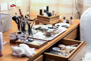 The dressing table is full of make-up cosmetics