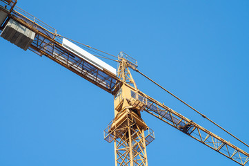 Yellow crane on a blue sky background