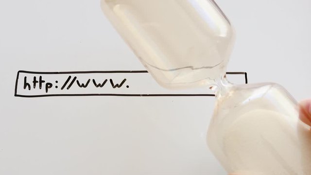 internet speed concept hand placing hourglass on whiteboard with URL bar and www written on it