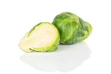 Group of one whole one half of fresh green brussels sprout isolated on white background