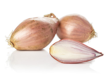Group of two whole one half of fresh brown shallot isolated on white background