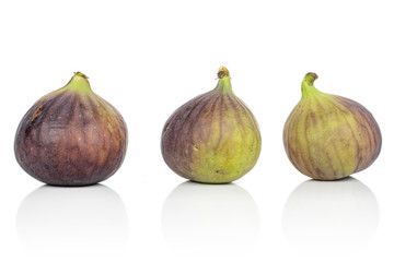 Group of three whole sweet purple fig isolated on white background