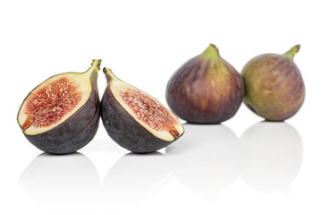 Group of two whole two halves of sweet purple fig isolated on white background