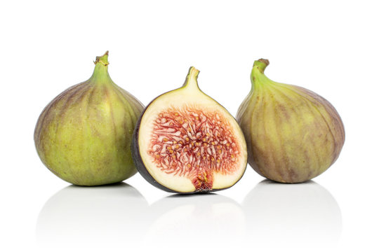 Group of two whole one half of sweet purple fig isolated on white background