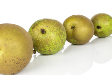 Group of four whole fresh green pear isolated on white background