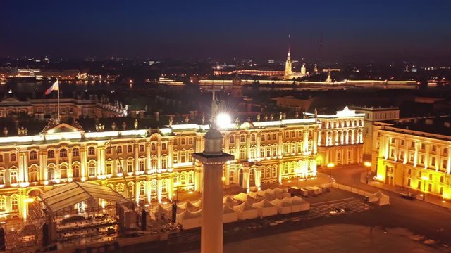 Aerial around view of the Alexander Column on Palace Square, the Winter Palace and the General Staff Building in St. Petersburg at night, Russia, 4k