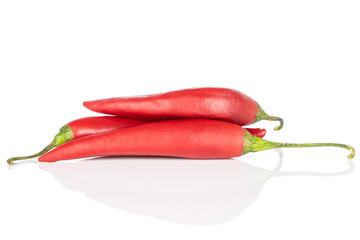 Group of three whole hot red chili cayenne isolated on white background