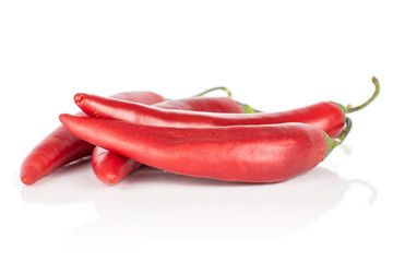 Group of four whole hot red chili cayenne isolated on white background