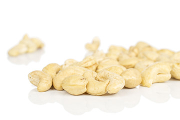 Lot of whole brown nut cashew heap isolated on white background