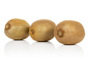 Group of three whole exotic brown kiwi isolated on white background
