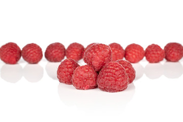Lot of whole fresh red raspberry isolated on white background