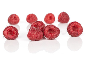 Group of nine whole fresh red raspberry isolated on white background