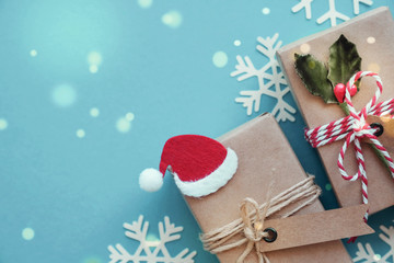 Eco gift boxes with Christmas snowflake decoration on green pastel background, Festive holidays background, new year 2020