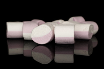Lot of whole light sweet pastel marshmallow isolated on black glass