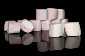 Group of thirteen whole sweet pastel marshmallow isolated on black glass