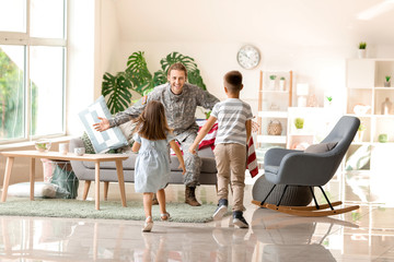 Happy children meeting their military father at home