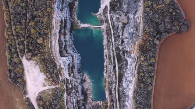 Beautiful aerial landscape of Velka Amerika old limestone mine has transformed into an amazing lake surrounded by mountains and forrest. It is amazing wonder of nature in Czechia. 