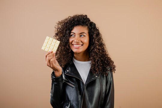 Beautiful Black Woman With White Chocolate Isolated Over Brown