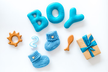 Boy's birthday concept. Set in blue colors with gift box on white backgound top view