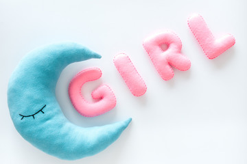 Baby shower concept. Word Girl and moon toy on white background top view copy space
