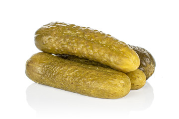 Group of four whole sour green pickle isolated on white background