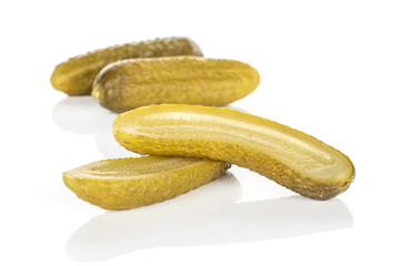 Group of two whole two halves of sour green pickle isolated on white background