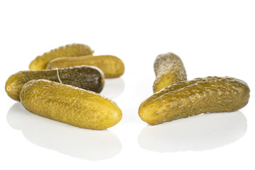 Group of six whole sour green pickle isolated on white background