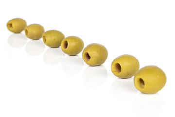 Group of seven whole marinated green olive isolated on white background
