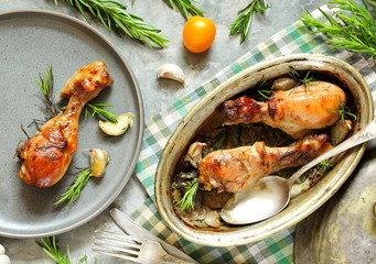Baked chicken drumsticks with rosemary on a concrete background. top view. copy space. keto recipe, low carb