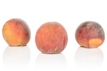 Group of three whole sweet red peach isolated on white background