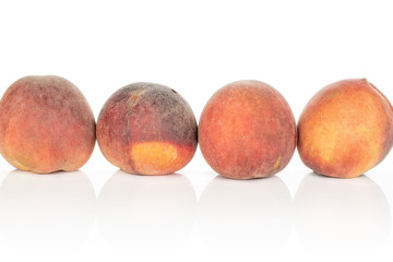 Group of four whole sweet red peach isolated on white background