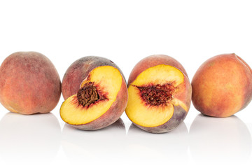Group of four whole two halves of sweet red peach isolated on white background