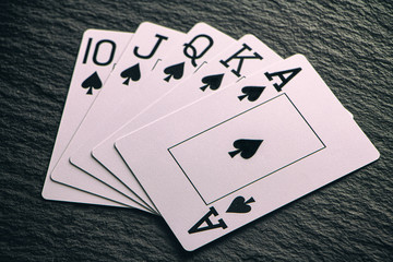 Royal Flush on a black background, a very rare poker hand