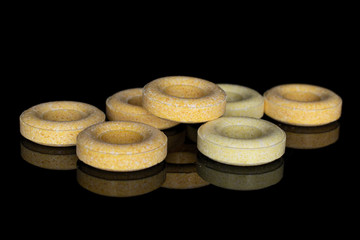 Fototapeta na wymiar Group of seven whole round pale yellow candy isolated on black glass