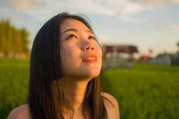 Fototapeta premium young happy and beautiful Asian woman enjoying nature at rice field. sweet Chinese girl exploring countryside during holiday travel in wanderlust and tourism concept