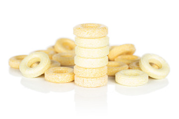 Lot of whole round pale yellow candy front focus isolated on white background