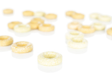 Lot of whole bright round pale yellow candy front focus isolated on white background