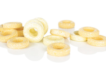 Lot of whole bright round pale yellow candy isolated on white background