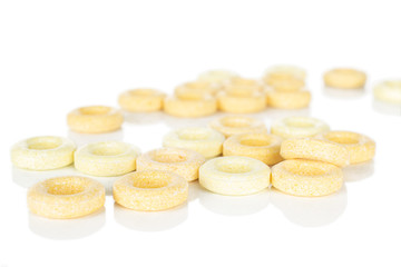 Lot of whole bright round pale yellow candy isolated on white background
