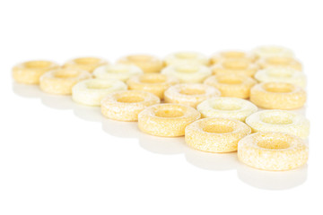 Lot of whole round pale yellow candy triangle isolated on white background