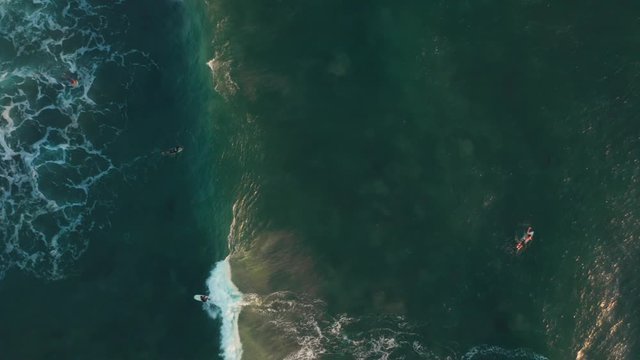 Top down view of surfers at Canggu. Aerial shot.